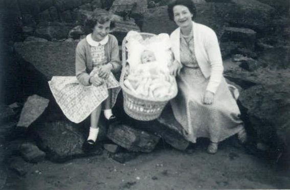 Anne Edmond in the crib with her mother (also called Anne) and cousin May Johnstone (although her surname was Tennant at the time of the photo).