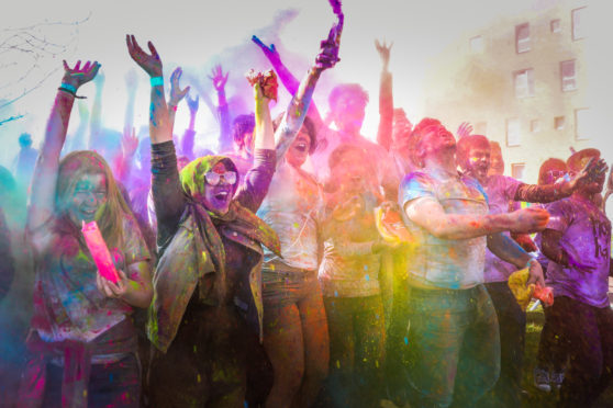 Students and staff of Dundee University celebrate Holi by throwing colour at each other