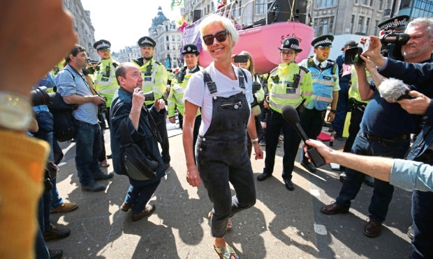 Actress Emma Thompson (centre) joins Extinction Rebellion demonstrators at Oxford Circus in London.