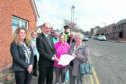 Evelyn Young and other members of the group with Lois Speed and PC David Voigt, handing a petition to Ian Cochrane , director of Infastructure Services at Angus Council
