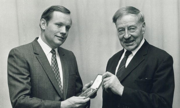 First man on the moon Neil Armstrong receives a Livingstone Medal from Lord Balerno of the Royal Scottish Geographical Society.