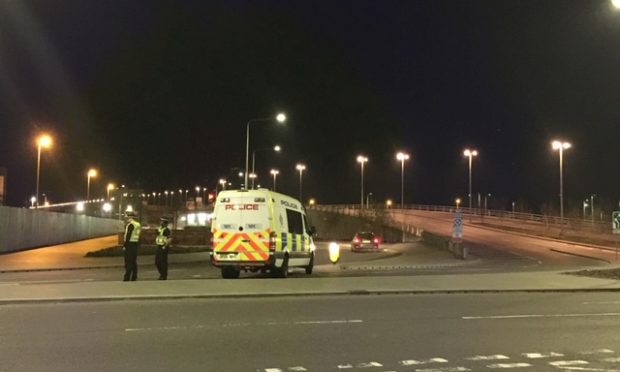 Police officers stopping traffic in Dundee