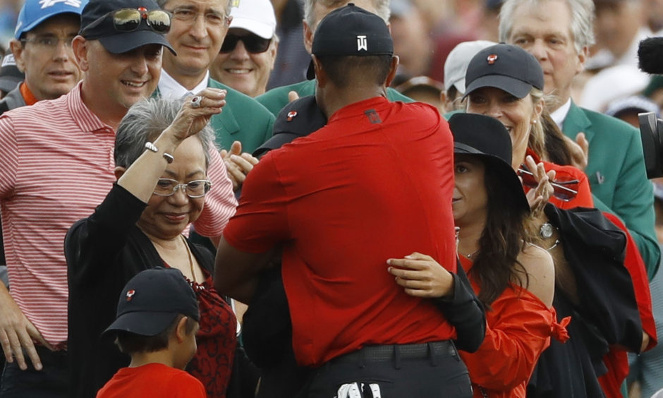 Tiger Woods hugs his family after winning the Masters.