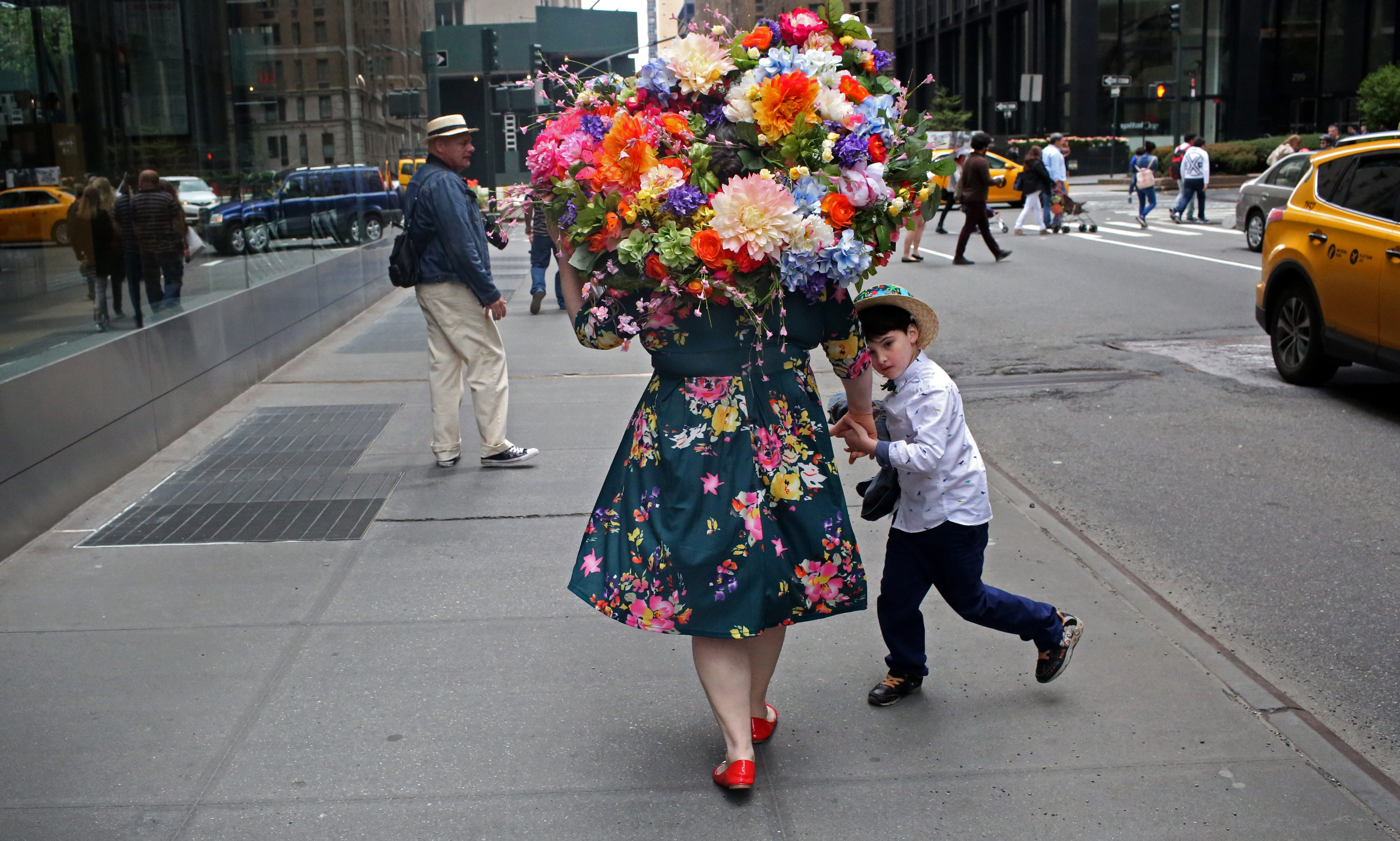 Laura Bopp wears a homemade flower hat while walking with her son Henry King, 7, in Midtown after the annual Easter Parade.