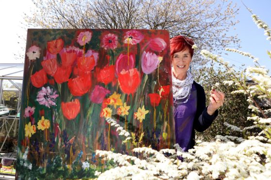 Trish Winton with one of her paintings