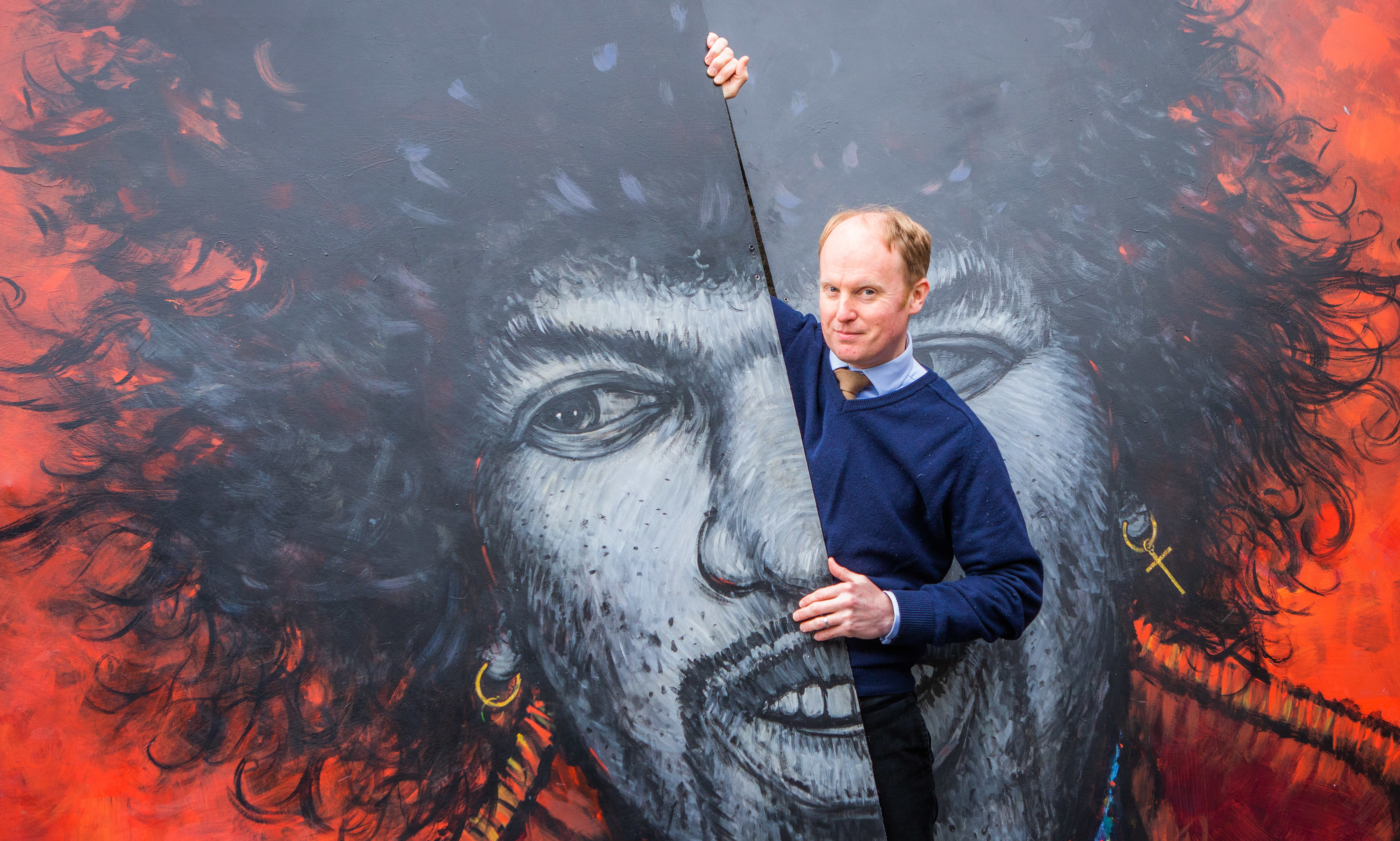 Auctioneer Nick Burns with the large-scale Hendrix portrait