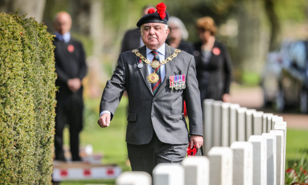 Major Ronnie Proctor, Provost of Angus, laying a wreath.
