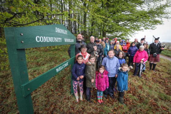 Members of the Dronley Community Woodland celebrating the purchase of Dronley Woods.