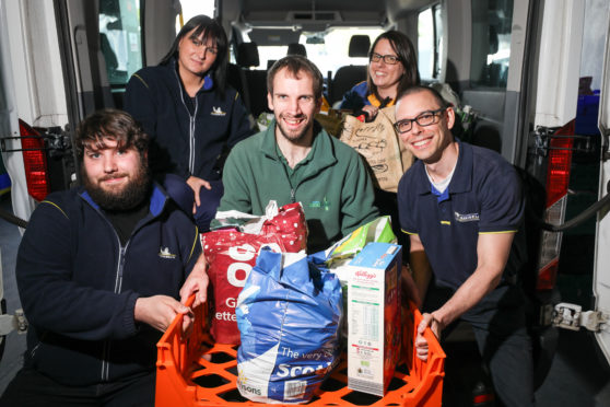 Michelin staff, from left, Scott Webster, Michelle Johnstone, Louise Smart and Peter Blanchard presenting the food to Michael Calder, stock coordinator at Dundee Foodbank.