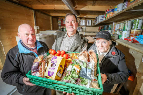 Norman Fox, distribution and driver, David Paton, Chair of Carnoustie Legion and Kirsty MacDonald, food handler and distributor, sorting out food donated by Tesco. Missing from the  picture is Gavin Wilson, the linchpin with FareShare.