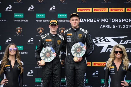 Sandy Mitchell and Andrea Amici on the Barber Park podium after race one