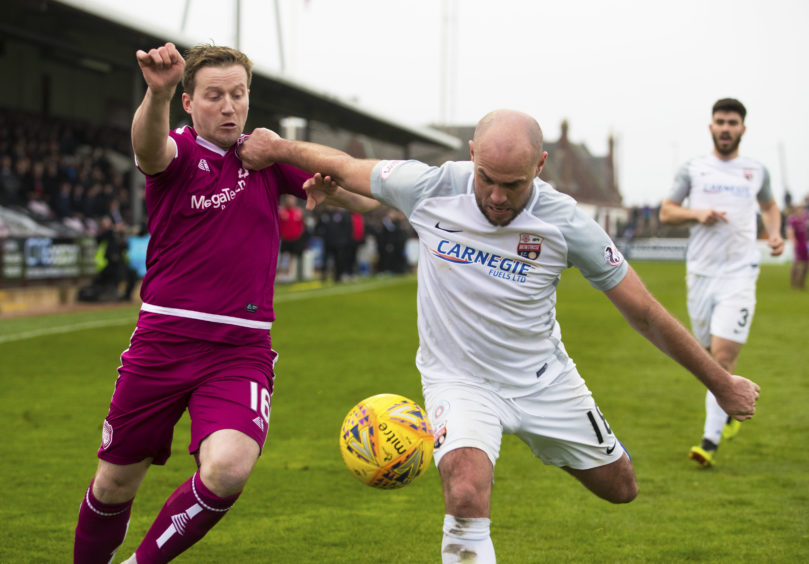 Arbroath's Steven Doris (L) in action with Montrose's Iain Campbell.