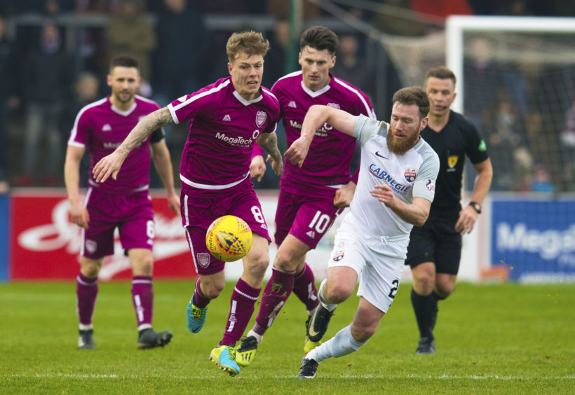Montrose's Patrick Cregg (R) in action with Arbroath's David Gold.