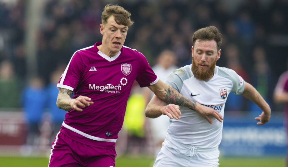 Montrose's Patrick Cregg (R) in action with Arbroath's David Gold.