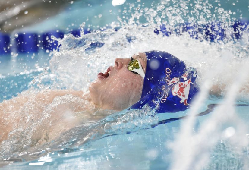 Nickolas Skelton competing in his heat of the Mens 100m Backstroke.