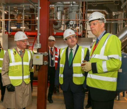 Paul Wheelhouse (centre) with Ross Vettraino (left) hears from Ian Clavert, of RWE, how the energy centre works