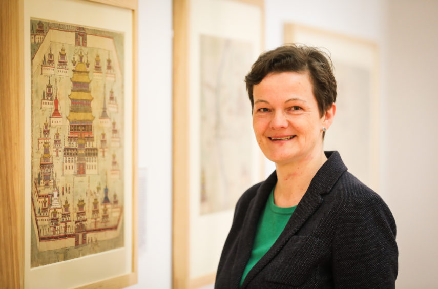 World mapping expert Dr Diana Lange from Humbolt University in Berlin pictured within Wise Collection exhibition at The McManus.