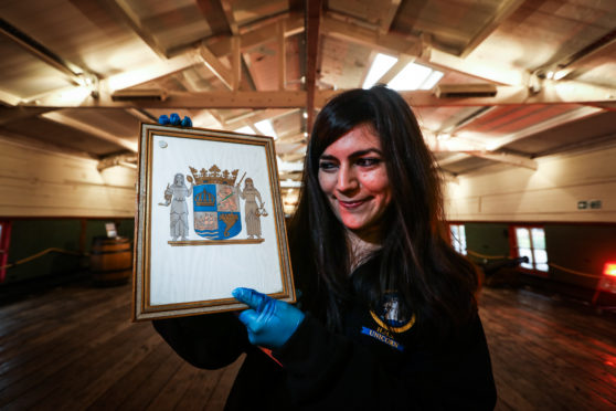 Federica Papiccio, HMS Unicorn's collection officer, with the Swedish coat of arms