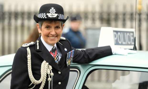 Commissioner of the Metropolitan Police Service Cressida Dick poses with an Austin 1100 police car  at Westminster Abbey.