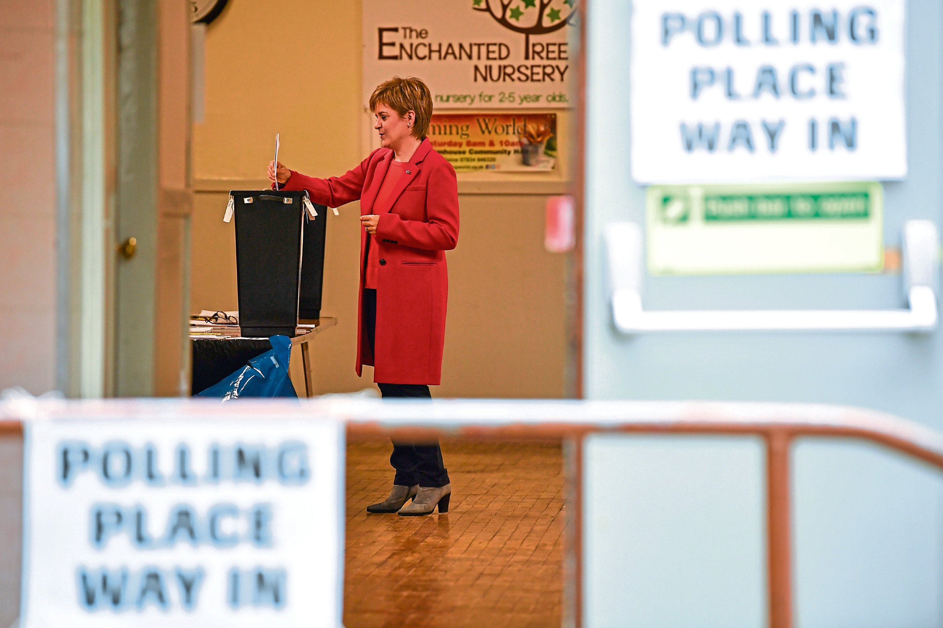 First Minister of Scotland and leader of the Scottish National Party, Nicola Sturgeon casts her vote in the European parliament election with her husband Peter Murrell at Broomhouse Community Hall.