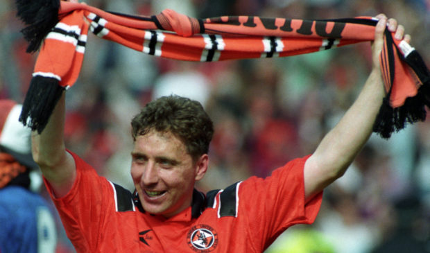 Jim McInally celebrates the cup win.