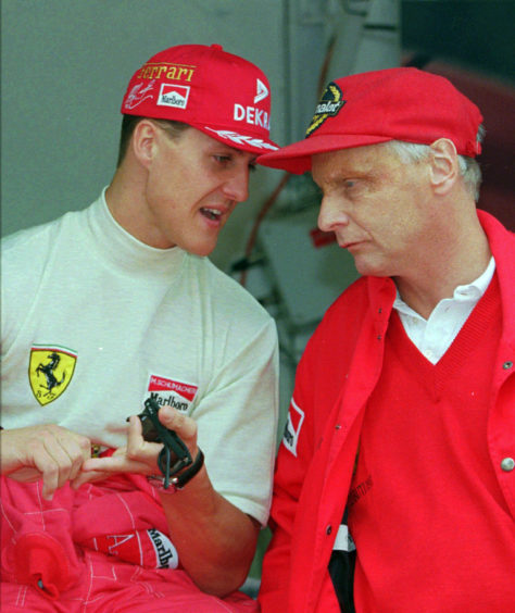1996 file photo defending champion Michael Schumacher of Germany, left, chats with Ferrari consultant Niki Lauda during the practice session for the Monaco F1 Grand Prix in the principality.