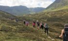A group of walkers enjoying the tranquil peace of the Angus Glens.