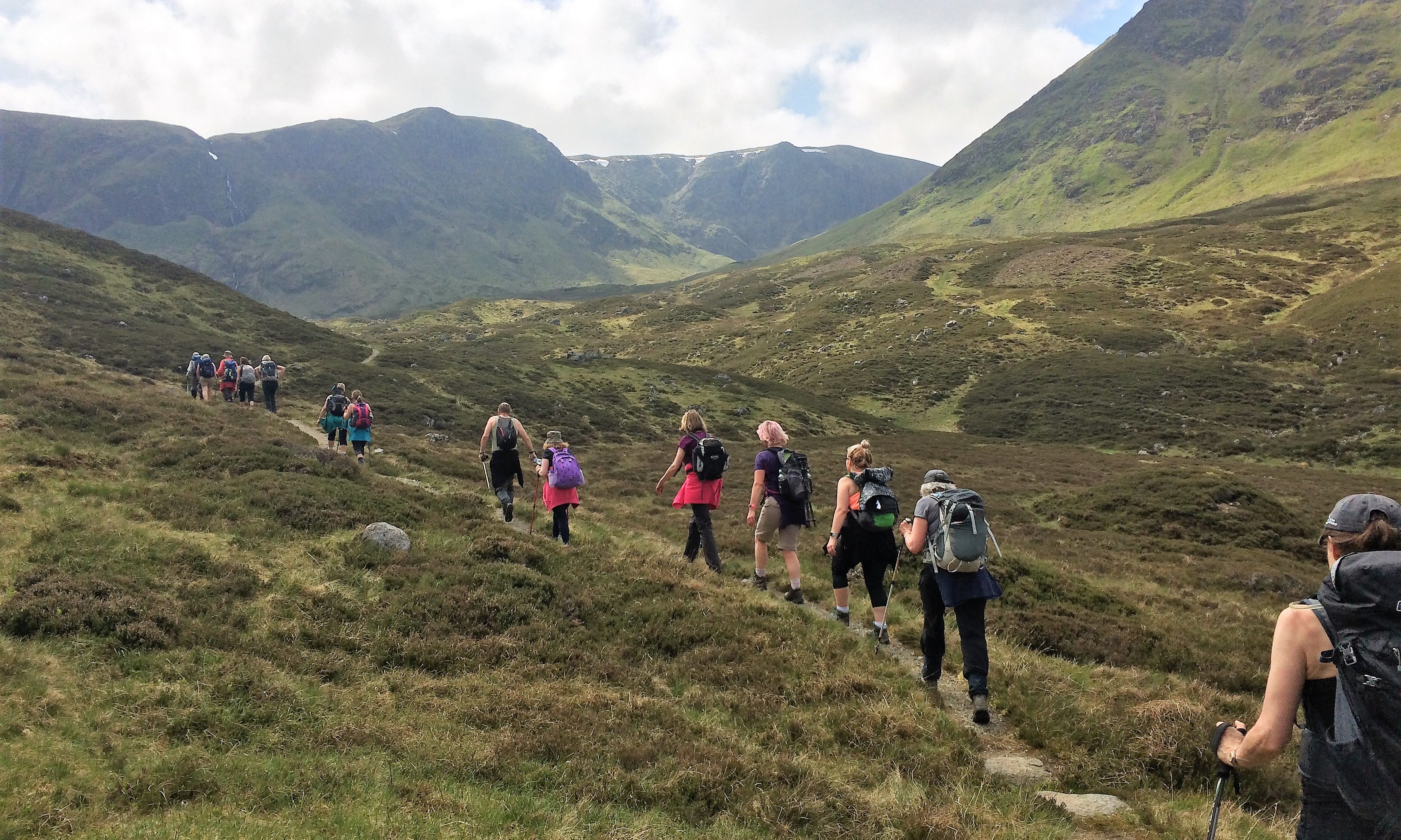 A group of walkers enjoying the tranquil peace of the Angus Glens.