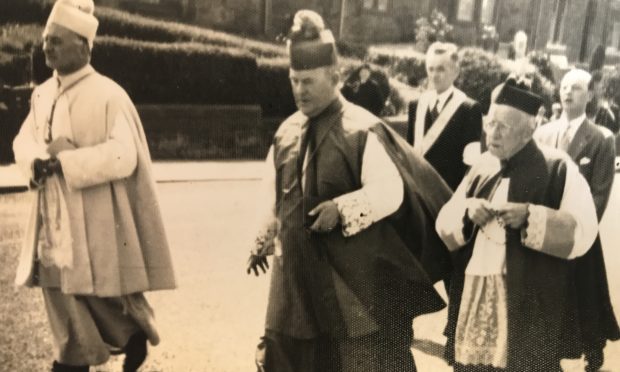 Clergy walk through the town, circa 1960s