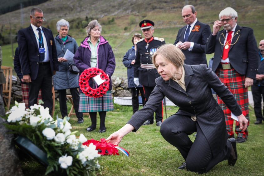 Anna Belorusova lays a wreath. The story was uncovered by Russian author Anna Belorusova, picutured laying a wreath, whose grandfather had served beside the men during the war.