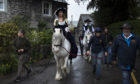 The King and the Queen walk the village bounds during 'Castleton Garland Day'.