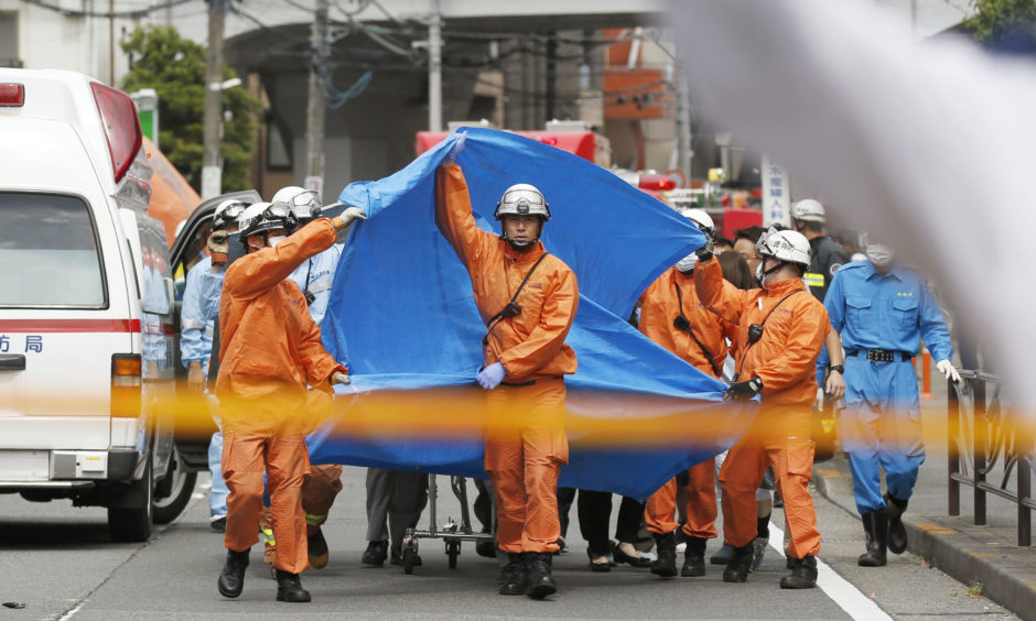 Rescuers work at the scene of an attack in Kawasaki.