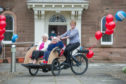 Residents, Ethel Candy and Sheila Banister and deputy manager, Lavine McMaster with the new trishaw.