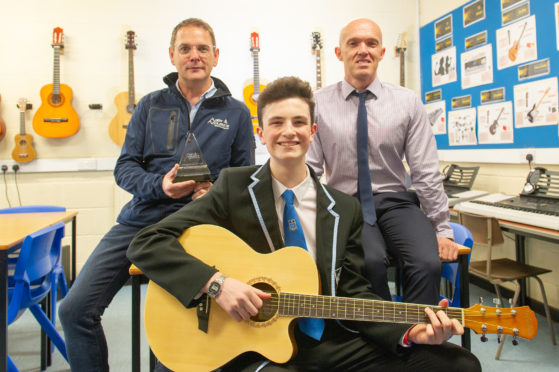 Pupil Adam Elder, 15, won first annual prize at Monifieth High SchooPaul Smith, Adam and music teacher, Stuart Brand