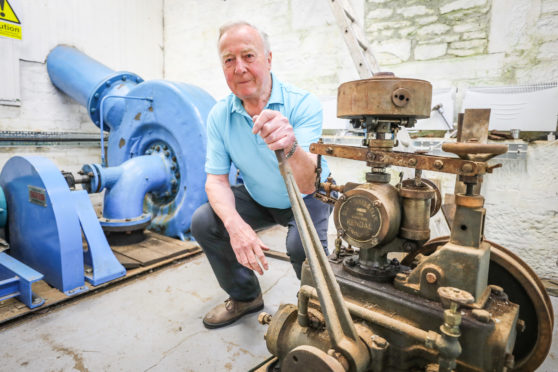 Duncan Stewart with the 100 year old turbine and governor