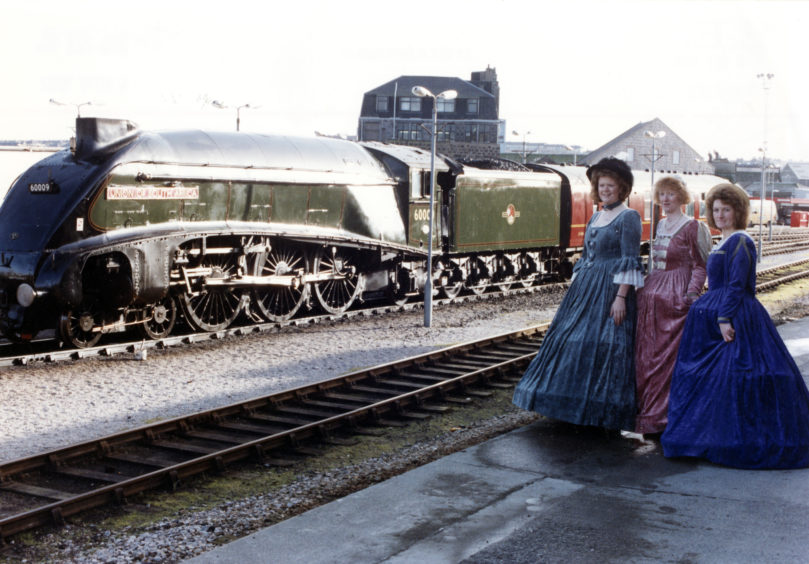 Joan Sinclair, Susan Thomson and Lorraine Ogg, with the A4 Pacific steam engine, as the Union of South Africa sits behind.