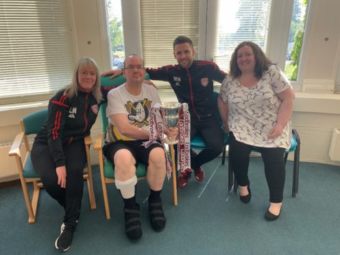 Neil and wife Natasha with club captain Mark Whatley and Lichties operations and kit manager Louise Walker