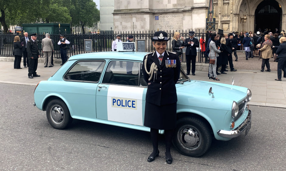 Metropolitan Police Comimssioner Cressida Dick stands with a vintage police car before going into Westminster Abbey for a special service on Friday, marking 100 years of women police officers in the Met.