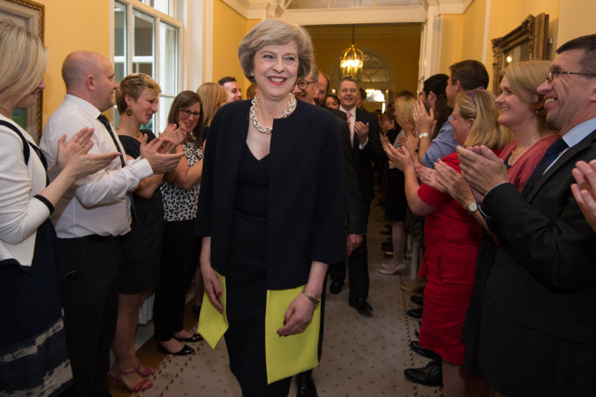 16 of staff clapping as Prime Minister Theresa May, followed by her husband Philip John, arrives at 10 Downing Street, London, after meeting Queen Elizabeth II and accepting her invitation to become Prime Minister and form a new government. The Prime Minister is expected to announce details later today of her timetable for leaving Downing Street.