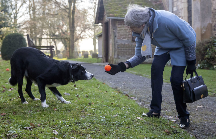 File photo dated 17/02/19 of Prime Minister Theresa May throwing a ball for a Border Collie called Blitz as she leaves after attending a church service near her Maidenhead constituency. The Prime Minister is expected to announce details later today of her timetable for leaving Downing Street.