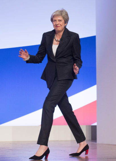 File photo dated 03/10/18 of Prime Minister Theresa May danceing as she arrives on stage to make her keynote speech at the Conservative Party annual conference. The Prime Minister is expected to announce details later today of her timetable for leaving Downing Street.