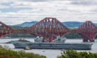 The HMS Queen Elizabeth sails under the Forth Bridges as she heads south from Rosyth, where she was built.