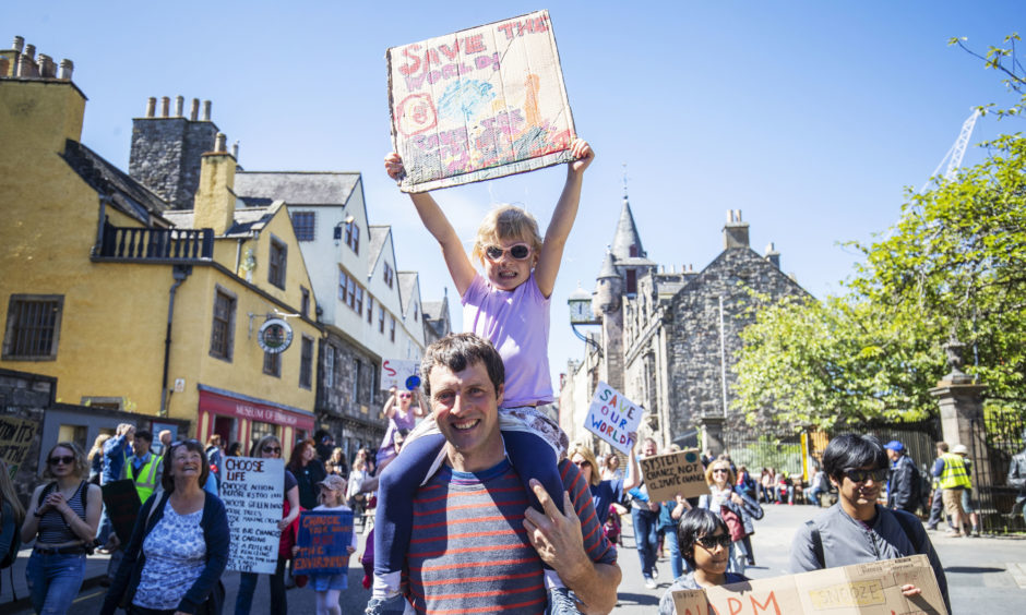 Alan Blackburn with his daughter Hanna Blackburn, five, join thousands of school children and students taking part in the Scottish Youth Climate Strike, in Holyrood to demand urgent action to tackle climate change.