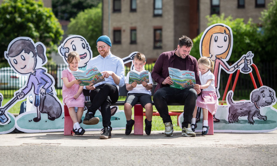 Children's author Ross McKenzie and illustrator Neil Slorance with schoolchildren as they read a new book, 'The Clumps' Big Mess'. The book, penned and illustrated by the two men, will be given to more than 14,000 school children as part of a council drive to combat littering.