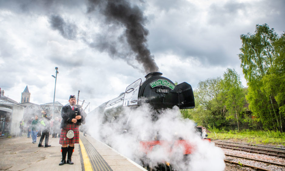 The Flying Scotsman steam train leaves from Perth train station as a lone piper plays. Rail enthusiasts across Tayside and Fife have gathered to catch a glimpse of the locomotive as it passes through on its way to Inverness. The steam engine arrived in Edinburgh on Thursday having made the trip up from York.
