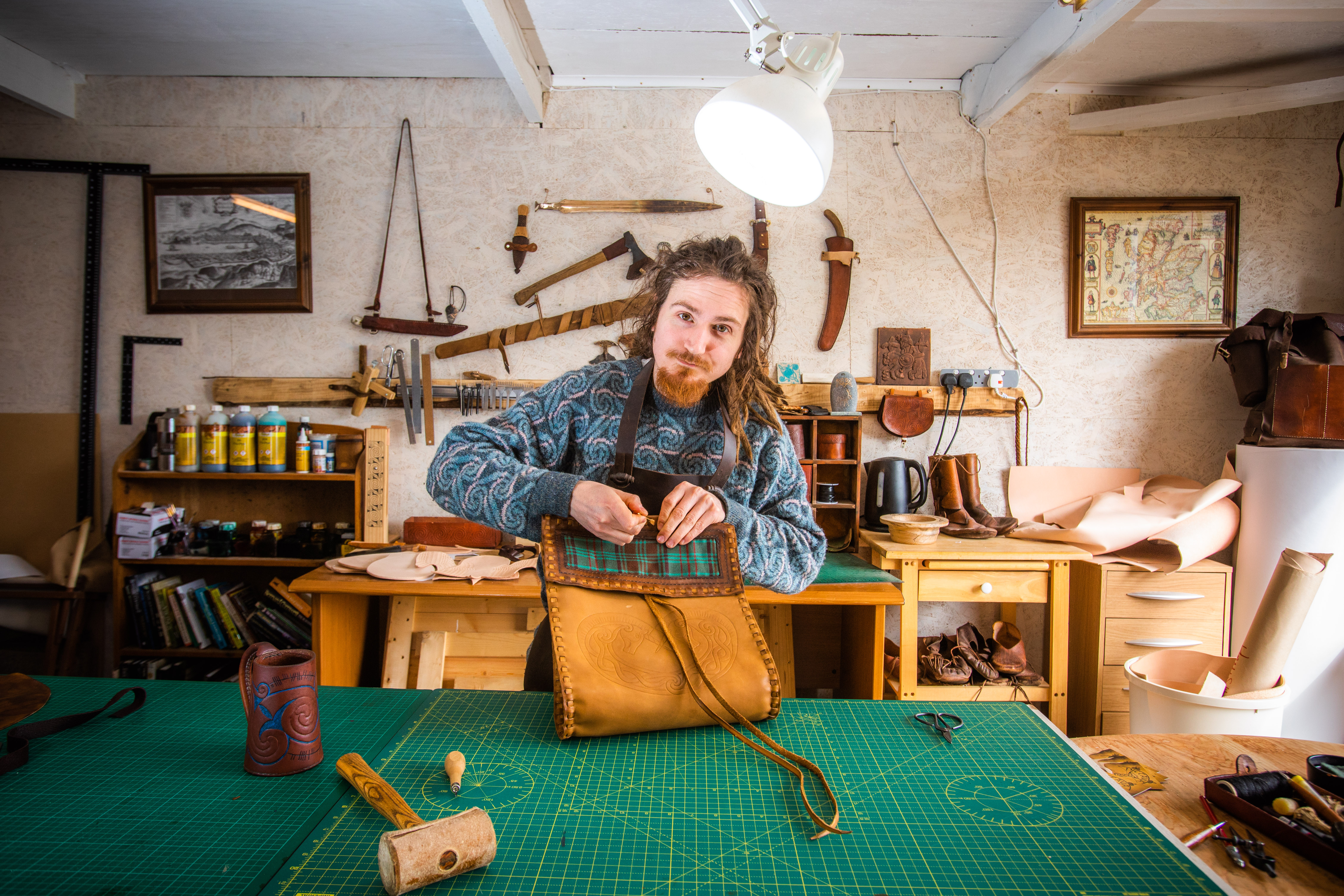 Hamish Lamley in his workshop working on a bag.