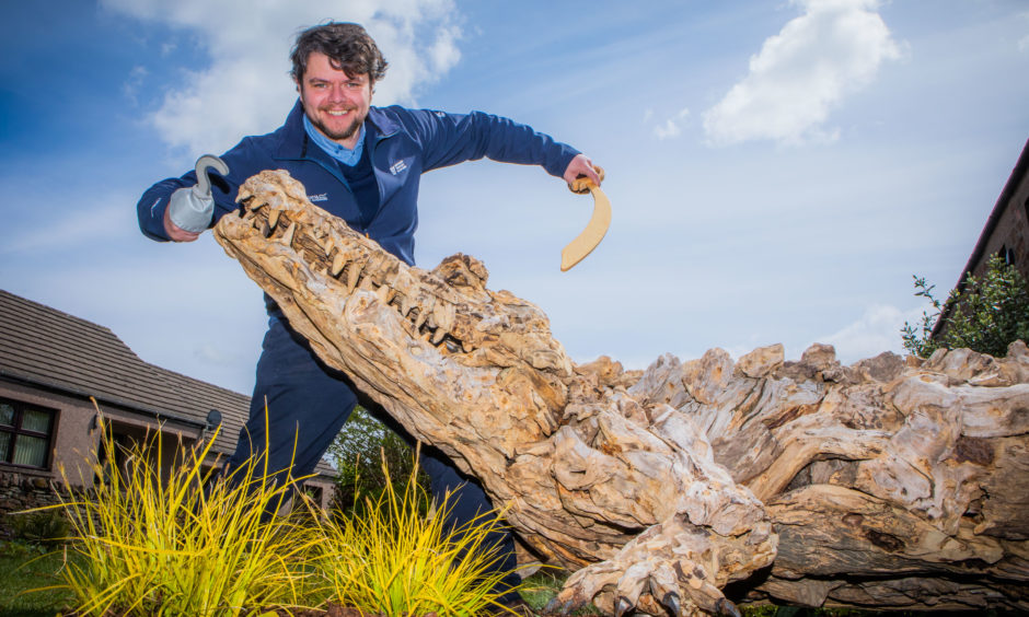 A celebration of the anniversary of J M Barrie's birth took place on Thursday 9 May at his birthplace in Kirriemuir. Cameron Hinde (Visitor Services Manager, Angus region) celebrates on the 159th anniversary of the novelists birth alongside a driftwood sculpture of 'Tick Tock' crocodile from Peter Pan. The sculpture was made by James Doran Webb.