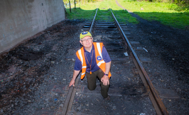 Rail campaign secretary Allen Armstrong examining the old railway line