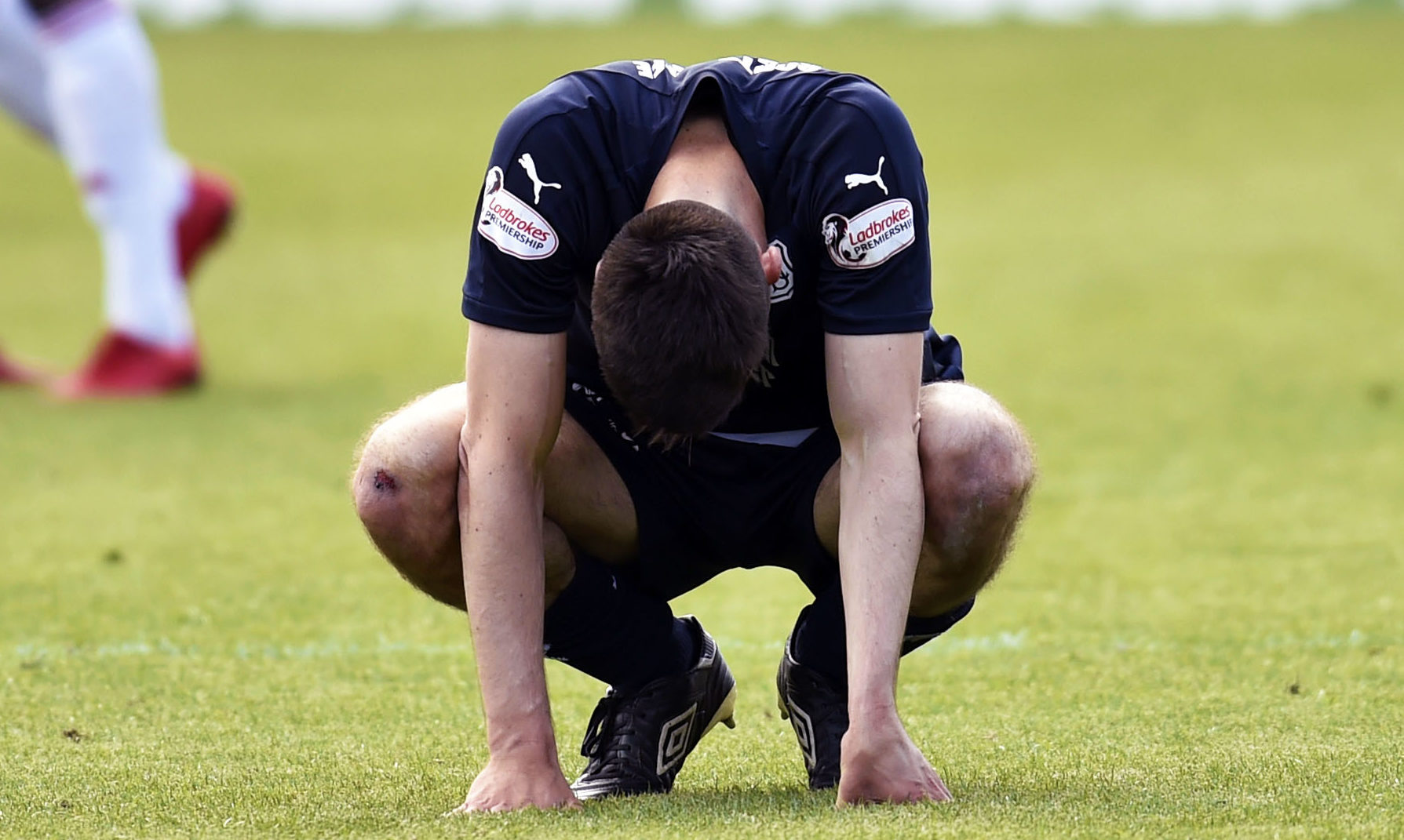 Dundee's Cammy Kerr trudges off the field following relegation from the Ladbrokes Premiership.