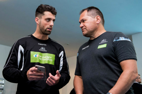 Glasgow Warriors head coach Dave Rennie (R) speaks with Adam Hastings.